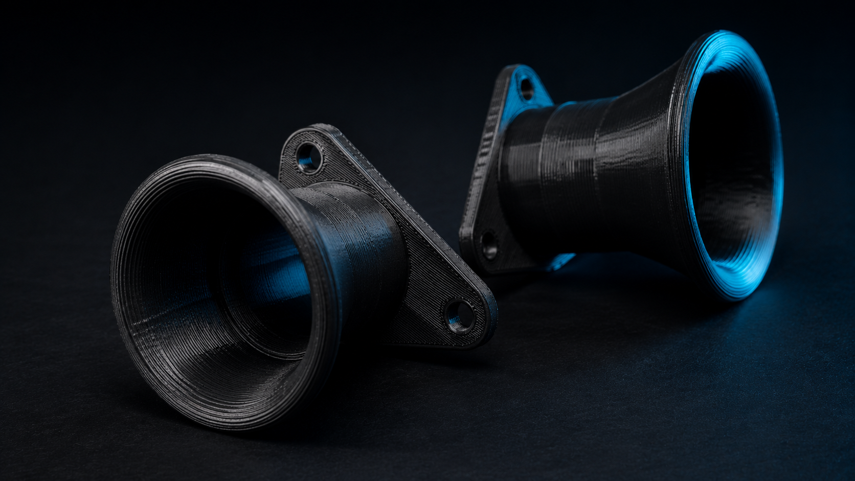 Two black 3D printed intake trumpets made at Zenki Lab